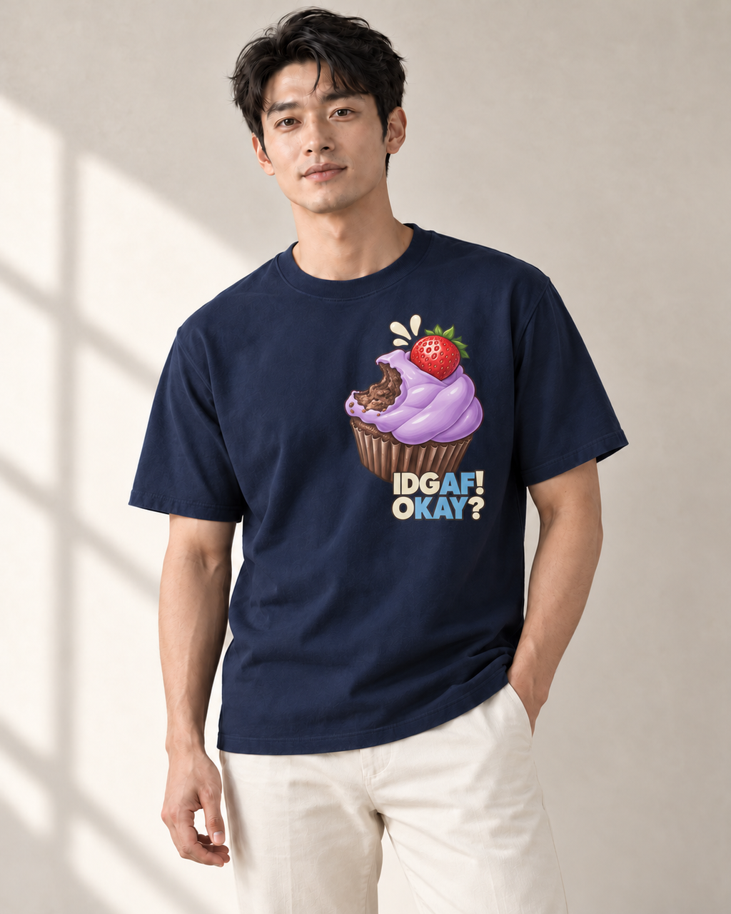 Adult model wearing the AFKAY Cupcake Tee in True Navy with offset cupcake front print.