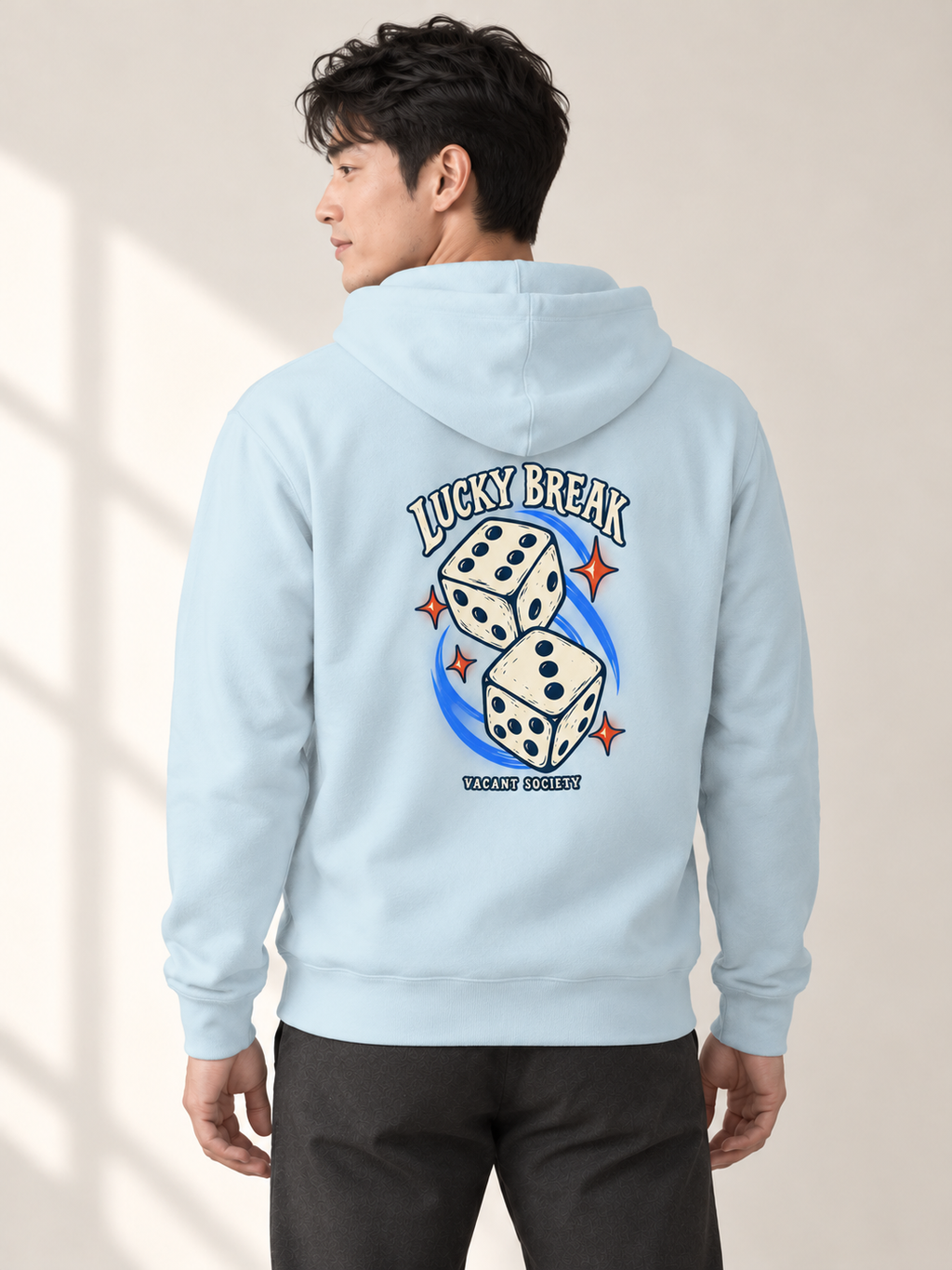 Adult model wearing the Lucky Break Hoodie in Sky Blue, showing the dice graphic on the back.